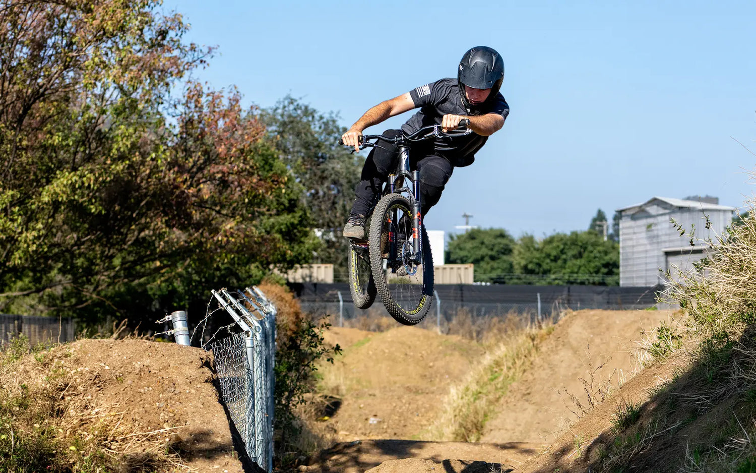 bmx rider jumping off dirt ramp